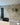 A light brick slip feature wall in a reclaimed style, with tiled flooring underneath.