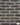 A brick slip panel image, close up of blend 109 - creased black, and cream mortar in the gaps
