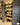 Red Brick Slip pillars with wooden shelving between them and more brick slips on the wall behind.
