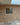 A simple cream multi brick slip creased and pointed with cream mortar, a single window is just off centre.