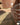 A rustic style brick slip retaining wall that leads from the camera away then to the left across shot.